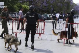 Tunisian anti-terrorism brigade officers lead their dogs after a shooting at the Bouchoucha military base in Tunis, Tunisia May 25, 2015. A Tunisian soldier opened fire on colleagues at a military base in the capital Tunis on Monday, killing a colonel and wounding eight other soldiers before he was shot dead himself, an army spokesman and a security source said. REUTERS/Zoubeir Souissi