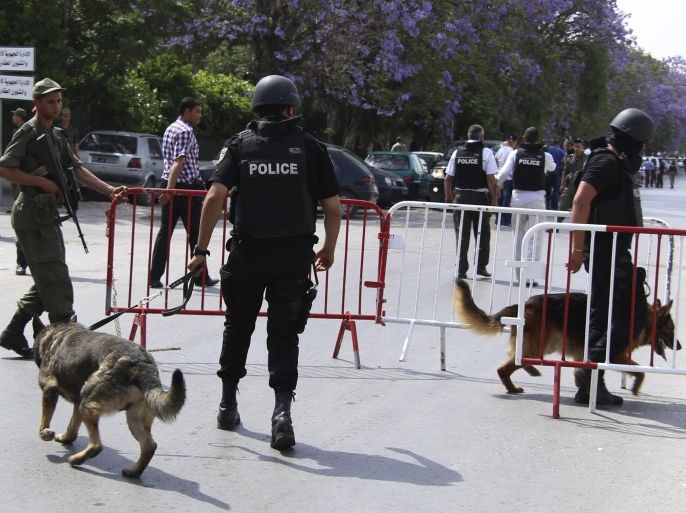 Tunisian anti-terrorism brigade officers lead their dogs after a shooting at the Bouchoucha military base in Tunis, Tunisia May 25, 2015. A Tunisian soldier opened fire on colleagues at a military base in the capital Tunis on Monday, killing a colonel and wounding eight other soldiers before he was shot dead himself, an army spokesman and a security source said. REUTERS/Zoubeir Souissi
