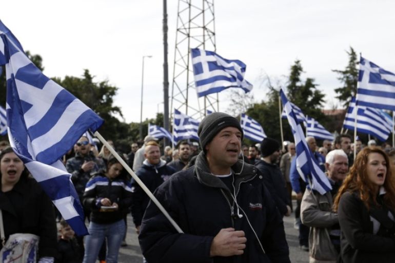 Protesters shout slogans during a rally organized by the extreme right Golden Dawn party against plans to build a new transit camp for refugees and migrants in the western Athens' suburb of Schisto, on Monday, Feb. 8, 2016. Greek Defense Minister Panos Kammenos says the country will complete new migrant screening centers and transit camps within a week, despite long delays and local protests against some of the projects. (AP Photo/Thanassis Stavrakis)