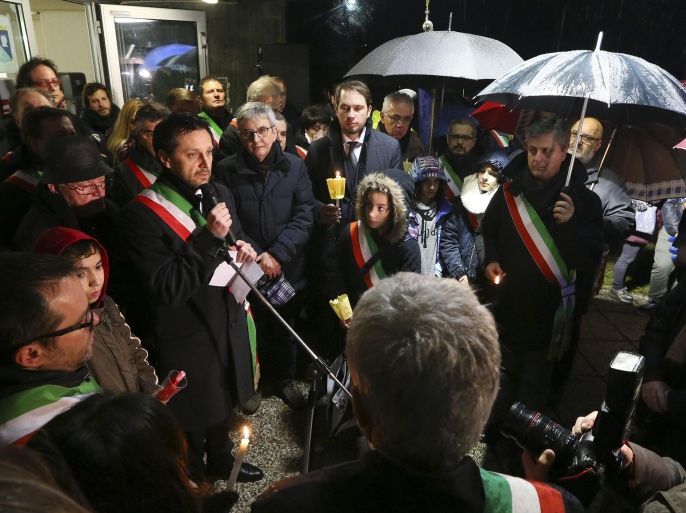 Fimuicello's Mayor Ennio Scridel delivers his speech during a candle lights procession to honor the memory of Giulio Regeni in his hometown of Fiumicello, Italy, Sunday, Feb. 7, 2016. Regeni, 28, an Italian doctoral student disappeared in Cairo on Jan. 25, the anniversary of Egypt's 2011 uprising, a day when security forces were on high alert and on the streets in force to prevent any demonstrations or protests. His body, stabbed repeatedly and exhibiting cigarette burns and other signs of torture, was reported found on Feb. 3. (AP Photo/Paolo Giovannini)