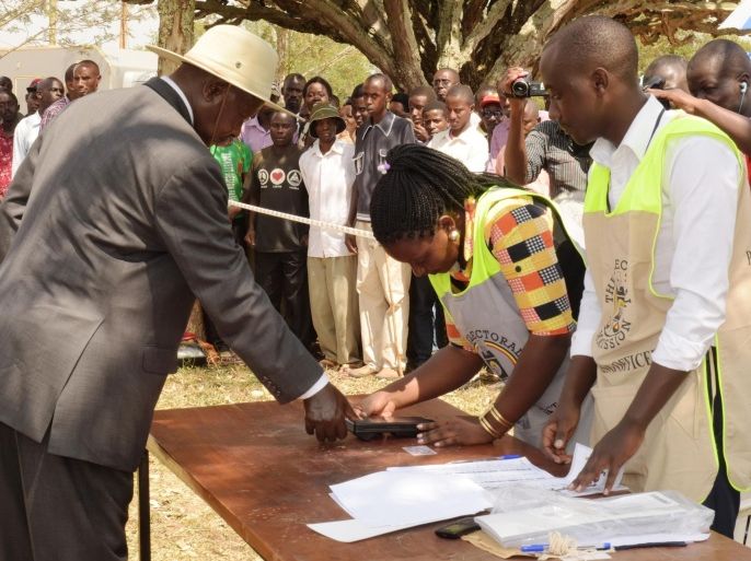 Uganda President Yoweri Museveni puts his thumb on to an ink pad after casting his vote in Kaaro High School in Kiruhura district about 350 kilometers west of the capital Kampala Thursday Feb. 18, 2016. Ugandans went to the polls Thursday as President Yoweri Museveni, in power for 30 years, is facing his tightest race ever with opposition leader Kizza Besigye his main challenger."(AP Photo/Stephen Wandera)