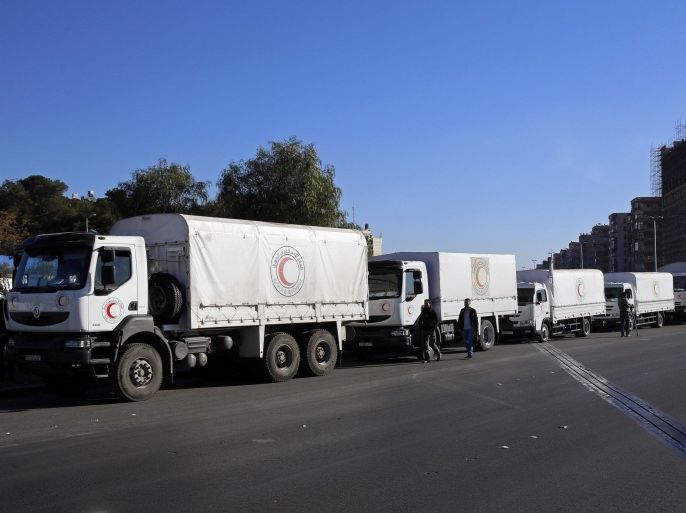 A convoy of humanitarian aid waits in front of the United Nations Relief and Works Agency (UNRWA) offices before making their way into the government besieged rebel-held towns of Madaya, al-Zabadani and al-Moadhamiya in the Damascus countryside, as part of a U.N.-sponsored aid operation, in Damascus, Syria, Wednesday, Feb. 17, 2016. A similar convoy is headed to the villages of Foua and Kfraya in the northern Idlib province, which are besieged by rebels. The convoys represent the third humanitarian aid delivery to the besieged communities after two similar efforts last month. (AP PHOTO)