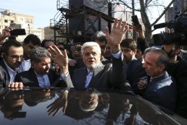 Head of the reformists' coalition list of the Iranian parliamentary elections in Tehran, Mohammad Reza Aref waves as he gets into his car after casting his vote at a polling station in northern Tehran, Iran, Friday, Feb. 26, 2016. Iranians across the Islamic Republic voted Friday in the country's first election since its landmark nuclear deal with world powers, deciding whether to further empower its moderate president or side with hard-liners long suspicious of the West. (AP Photo/Vahid Salemi)