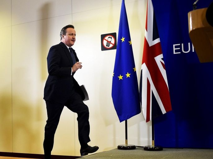 British Prime Minister David Cameron jumps up on stage as he prepares to address the media after a European Union leaders' summit in Brussels, Belgium, February 19, 2016. Cameron said on Friday he would campaign with all his "heart and soul" for Britain to stay in the European Union after he won a deal about the so-called Brexit, in Brussels which offered his country "special status". REUTERS/Dylan Martinez