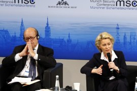 German Minister of Defense, Ursula von der Leyen, right, gestures on the podium besides French Minister of Defense, Jean-Yves Le Drian at the Munich Security Conference in Munich, Germany, Friday, Feb. 12, 2016. (AP Photo/Matthias Schrader)