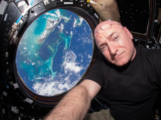 In this July 12, 2015 photo, Astronaut Scott Kelly takes a photo of himself inside the Cupola, a special module of the International Space Station which provides a 360-degree viewing of the Earth and the station. (Scott Kelly/NASA via AP)