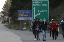 Migrants walk along a road towards the Macedonian-Greek border, near the town of Polikastro, Greece February 23, 2016. REUTERS/Marko Djurica