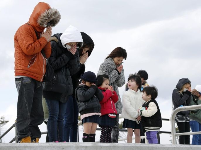 People offer a minute of silence for the victims at tsunami-devastated Abraham, coastal district of Sendai, northern Japan, at 14:46, 11 March 2016. Japan marked the fifth anniversary of the earthquake and tsunami on 11 March 2016. About 15,894 people were killed in the disaster and 2,562 are still missing, according to Japan's National Police Agency as of February 2016. Some 174,471 people are still living in shelters.