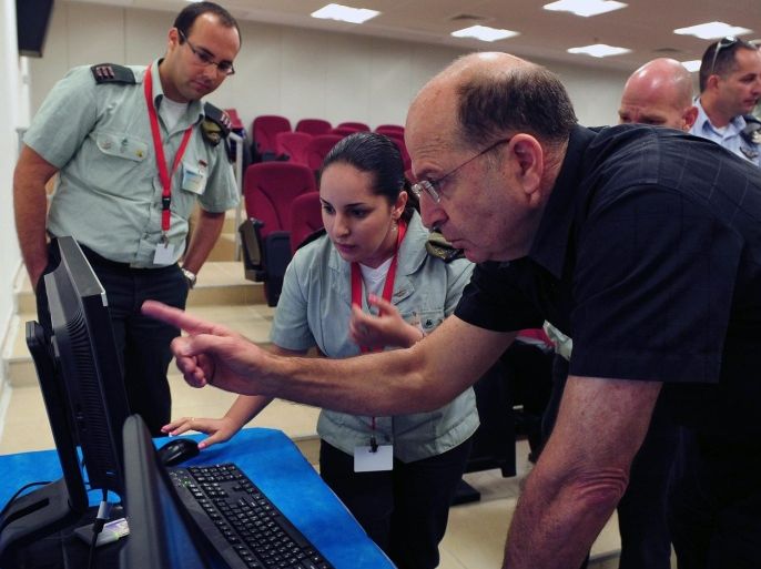 A photograph supplied by the Israeli Defense Ministry shows Israeli Defense Minister Moshe Yaalon as he looks at material shown on a computer monitor during a visit to the Israeli Defense Forces cyber warfare unit in Tel Aviv, Israel, 04 June 2013.