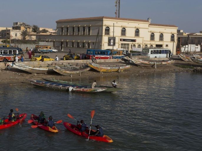 A group of young Senegalese kayak on the Senegal river, in Saint-Louis, Senegal, Saturday, May 18, 2013. Saint-Louis, once the capital of colonial French West Africa, is hosting the 21st edition of its annual Jazz Festival from May 15 to 19. (AP Photo/Rebecca Blackwell)