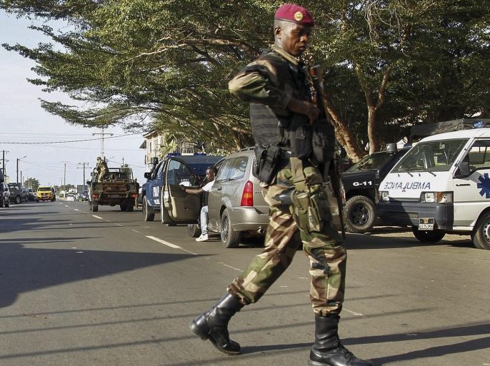 An Ivorian soldier secures the road outside of the 'Etoile du Sud' hotel in Grand Bassam, Ivory Coast, 13 March 2016. According to reports fourteen civilians and six assailants were killed when gunmen opened fire on guests at the 'Etoile du Sud' hotel in the town of Grand Bassam which is popular with foreigners.