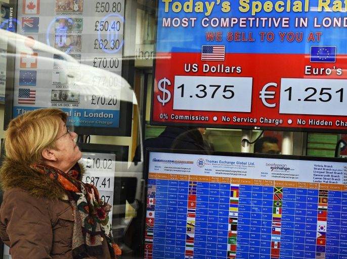 A customer looks over exchange rates at a money exchange in London, Britain, 24 February 2016. The British pound continued to fall further against the dollar over concerns on the economy and Brexit fears.