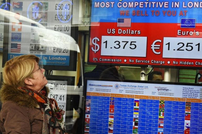 A customer looks over exchange rates at a money exchange in London, Britain, 24 February 2016. The British pound continued to fall further against the dollar over concerns on the economy and Brexit fears.