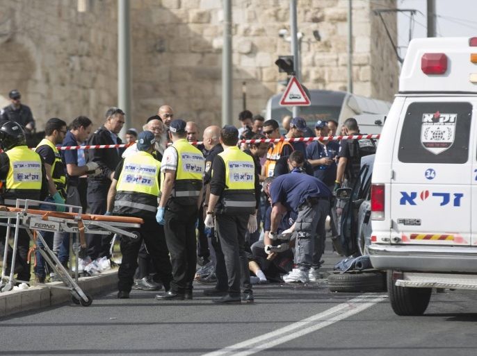 Israeli police and medical personnel inspect the body of a Palestinian man at the scene of the shooting attack near Damascus Gate in the Old City of Jerusalem, Israel, 09 March 2016. According to media reports, two Palestinians were shot dead by Israeli security forces following an attack that injured an Israeli man. The two were thought to have been involved in an earlier shooting incident involving an Israeli bus, according to police.