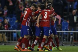Atletico Madrid players celebrate after scoring the opening goal against Real Sociedad during a Spanish La Liga soccer match between Atletico Madrid and Real Sociedad at the Vicente Calderon stadium in Madrid, Tuesday, March 1, 2016. (AP Photo/Francisco Seco)