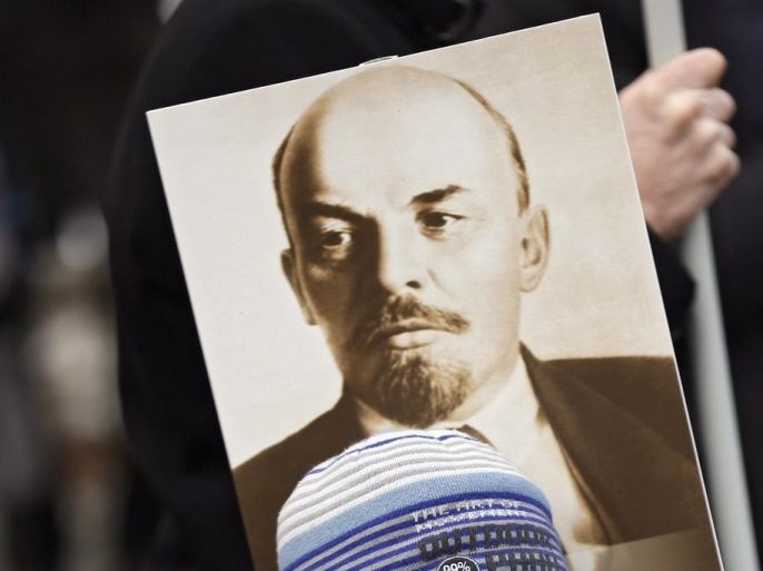 A Russian boy holds a portrait of Russian revolutionary leader Vladimir Illych Lenin during a demonstration celebration of the Defender of the Fatherland Day (former Soviet Army Day), in Moscow, Russia, 23 February 2016. Defender of the Fatherland Day is observed in most of Russia and former Soviet republics to commemorate the people serving in the Russian Armed Forces.