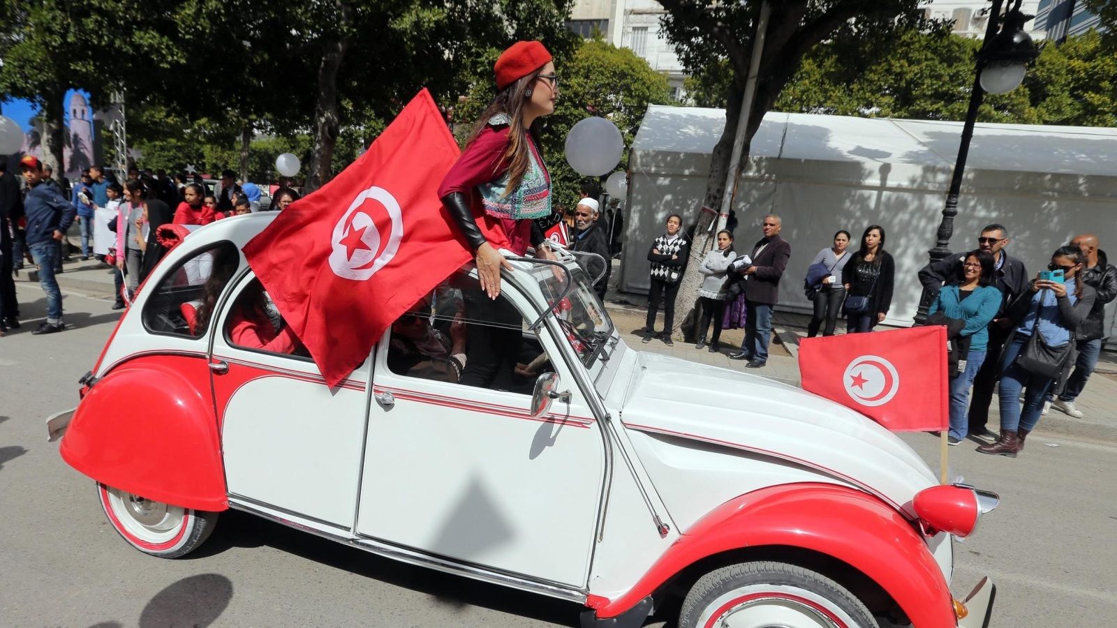 A Tunisian woman holdx national flag during a celebration to commemorate Tunisian National Day in Tunis, Tunisia, 20 March 2016. The day commemorates the country's independence from France in 1956.