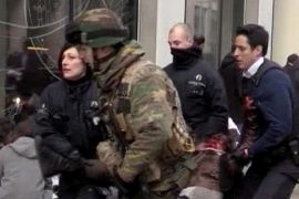 A TV grab image shows Belgian policemen and a soldier carrying an injured person after an explosion at the Maelbeek Metro station in Brussels, Belgium, 22 March 2016. Brussels has shut down its all of its metro services after blasts occurred in Schuman and Maelbeek metro stations near European Union buildings, local news reports. At least one person was killed and many injured, according to a local witness, although the number of deaths and injuries has not been confirmed by official sources. The blast comes just hours after dozens of people were killed or injured in a double explosion in the departure hall of Zaventem Airport in Brussels. EPA/STR BEST QUALITY AVAILABLE