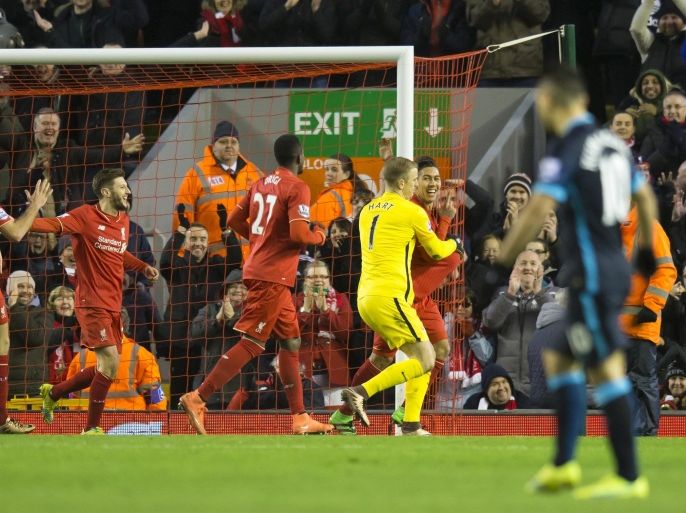 Liverpool's Roberto Firmino, right, celebrates after scoring as Manchester City's goalkeeper Joe Hart, in yellow, attempts to retrieve the ball from Firmino's shirt during the English Premier League soccer match between Liverpool and Manchester City at Anfield Stadium, Liverpool, England, Wednesday, March 2, 2016. (AP Photo/Jon Super)