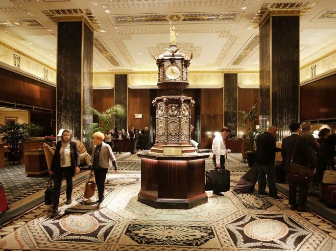 Guests pass through a lobby of the Waldorf Astoria hotel, Monday, Oct. 6, 2014 in New York. Hilton Worldwide is selling the Waldorf Astoria New York to Chinese insurance company Anbang Insurance Group Co. for $1.95 billion. Hilton Worldwide will continue to manage the storied hotel for the next 100 years as part of an agreement with Anbang. (AP Photo/Mark Lennihan)