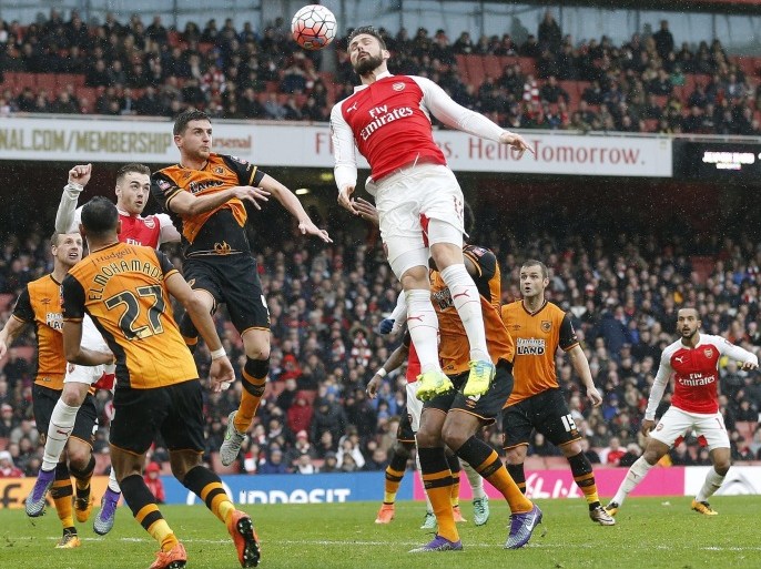 Arsenal's Olivier Giroud, center, heads the ball during the English FA Cup soccer match between Arsenal and Hull City at the Emirates stadium in London, Saturday, Feb. 20, 2016.(AP Photo/Frank Augstein)
