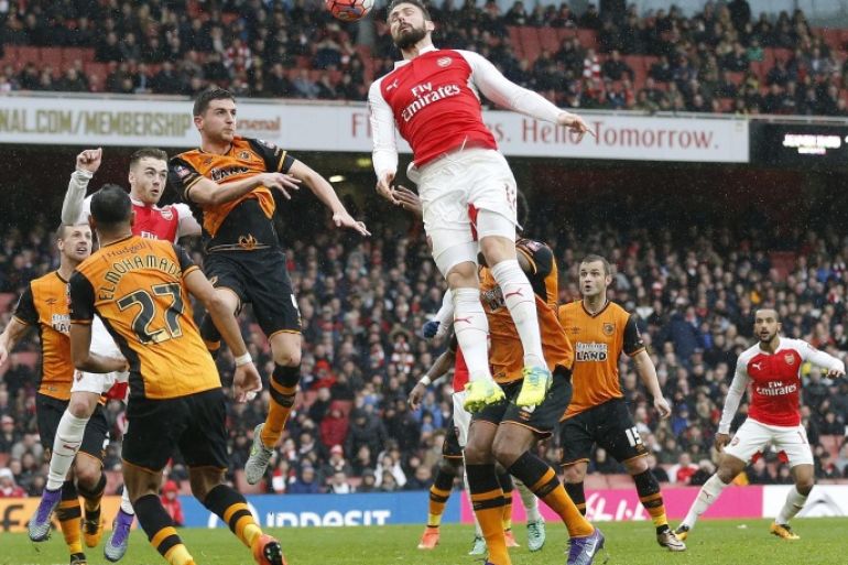 Arsenal's Olivier Giroud, center, heads the ball during the English FA Cup soccer match between Arsenal and Hull City at the Emirates stadium in London, Saturday, Feb. 20, 2016.(AP Photo/Frank Augstein)