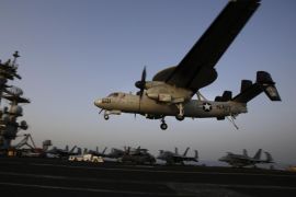 FILE - In this Aug. 10, 2014 file photo, an aircraft lands after missions targeting the Islamic State group in Iraq from the deck of the U.S. Navy aircraft carrier USS George H.W. Bush in the Persian Gulf. (AP Photo/Hasan Jamali, File)