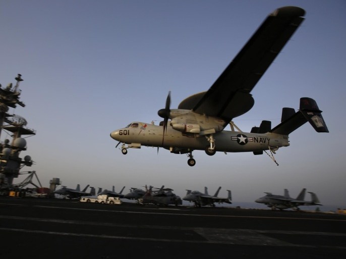 FILE - In this Aug. 10, 2014 file photo, an aircraft lands after missions targeting the Islamic State group in Iraq from the deck of the U.S. Navy aircraft carrier USS George H.W. Bush in the Persian Gulf. (AP Photo/Hasan Jamali, File)