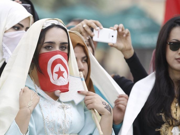 Women wear traditional veils known as "sefseri" on the National Day of Crafts and Traditional Dress in Tunis, Tunisia March 20, 2016. REUTERS/Zoubeir Souissi