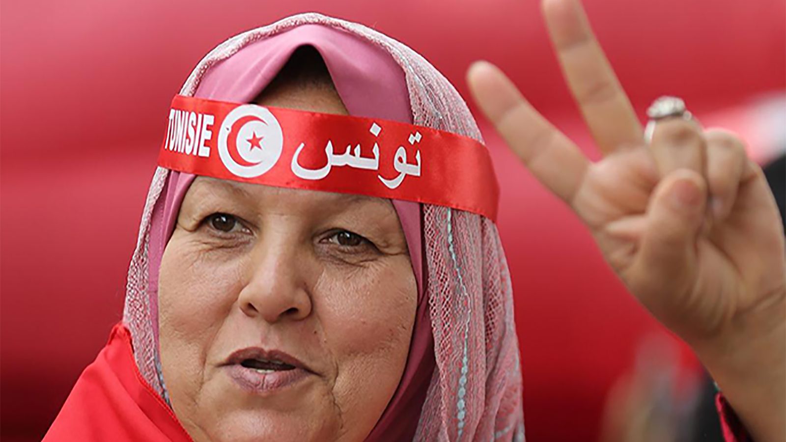 A Tunisian woman flashes the V for victory sign during a celebration to commemorate Tunisian National Day in Tunis, Tunisia, 20 March 2016