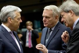 Belgian Foreign Minister Didier Reynders, left, speaks with Italian Foreign Minister Paolo Gentiloni, right, and French Foreign Minister Jean-Marc Ayrault during a meeting of EU foreign ministers at the EU Council building in Brussels on Monday, March 14, 2016. EU foreign ministers on Monday will discuss Iran, Russia and the current situation in Libya. (AP Photo/Virginia Mayo)