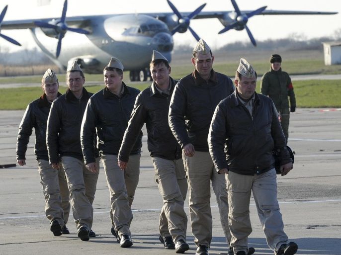 Russian pilots march after returning from Syria at a Russian air base in Primorsko-Akhtarsk, southern Russia, Wednesday, March 16, 2016. More Russian planes returned from Syria on Wednesday, two days after President Vladimir Putin ordered Russian military to withdraw most of its fighting forces from Syria, signaling an end to Russia's five-and-a-half month air campaign. (AP Photo)