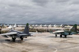 In this photo provided by the Russian Defense Ministry Press Service, a lineup of Russian troops is held before withdrawal at Hemeimeem air base in Syria, Tuesday, March 15, 2016. Russian warplanes and troops stationed at Russia's air base in Syria started leaving for home on Tuesday after a partial pullout order from President Vladimir Putin the previous day, a step that raises hopes for progress at the newly reconvened U.N.-brokered peace talks in Geneva. (Vadim Grishankin/Russian Defense Ministry Press Service via AP)
