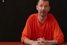 FILE - In this file still image taken from an undated video published on the Internet by Al-Furqan, the media arm of the Islamic State group militants, captive British journalist John Cantlie speaks into the camera on the first of what he says will be a series of lecture-like "programs" in which he says he will reveal "the truth" about the Islamic State group. The British photojournalist has been used by the Islamic State group to take on the role of a war correspondent. He has appeared in several videos delivering statements, purportedly from Kobani and Mosul, likely under duress. Cantlie has worked for several publications including The Sunday Times, The Sun and The Sunday Telegraph. The Arabic subtitle reads "I am a prisoner and that is something I will not deny." (AP Photo, File)