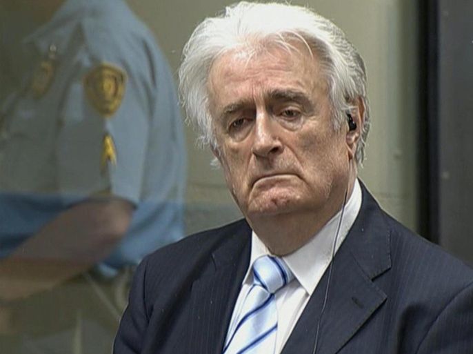 In this image taken from video Bosnian Serb wartime leader Radovan Karadzic listens to the verdict at the International Criminal Tribunal for Former Yugoslavia (ICTY) in The Hague, The Netherlands Thursday March 24, 2016. Karadzic was convicted of genocide and nine other charges Thursday at a U.N. court, and sentenced to 40 years in prison. (ICTY, Pool via AP)
