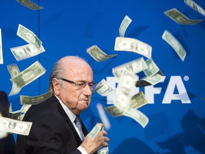 (FILE) A file picture dated 20 July 2015 of FIFA president Joseph Blatter reacting while banknotes thrown by British Comedian Simon Brodkin hurtle through the air during a press conference following the extraordinary FIFA Executive Committee at the FIFA headquarters in Zurich, Switzerland. FIFA president Joseph Blatter has been provisionally suspended for 90 days by the FIFA ethics committee, media reports stated on 07 October 2015. EPA/ENNIO LEANZA *** Local Caption *** 52063121
