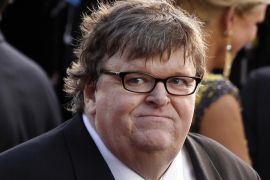 FILE- In this Feb. 26, 2012, file photo, filmmaker Michael Moore arrives before the 84th Academy Awards in the Hollywood section of Los Angeles. Moore has filed for divorce after 21 years of marriage to Kathleen Glynn, his collaborator on the Oscar-winning "Bowling for Columbine" and other projects. A final hearing is scheduled for Sept. 10, 2013. (AP Photo/Joel Ryan, File)