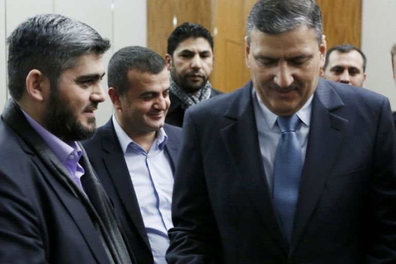 Riad Hijab (R) Syrian opposition coordinator for the High Negotiations Committee (HNC) shakes hand with Mohamed Alloush of the Jaysh al Islam after a news conference after the Geneva peace talks were paused in Geneva, Switzerland, February 3 , 2016. U.N.-mediated talks to end the war in Syria are on pause until Feb. 25, U.N. envoy Staffan de Mistura said on Wednesday, saying the talks had not failed but needed immediate help from international backers led by the United States and Russia. REUTERS/Pierre Albouy