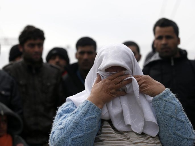 A migrant woman reacts during a protest demanding the opening of the border between Greece and Macedonia in the northern Greek border station of Idomeni, Greece, Sunday, March 27, 2016. A split appears to have developed among the groups of migrants at the Idomeni border encampment, with Greek riot police who, so far, have used only their shields to protect the border. (AP Photo/Darko Vojinovic)