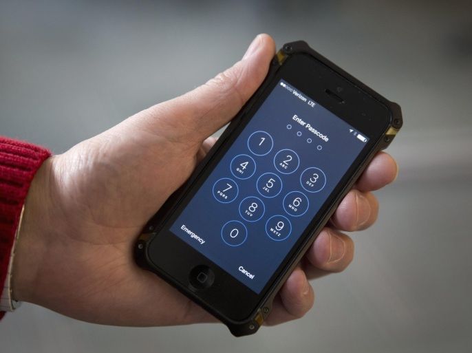 FILE - In this Feb. 17, 2016 file photo shows an iPhone in Washington. A schism has emerged among family members of victims and survivors of the San Bernardino, California terrorist attack, with at least a couple supporting Apple Inc. in its battle against a federal court order to help the FBI hack into a shooter’s locked iPhone. (AP Photo/Carolyn Kaster)