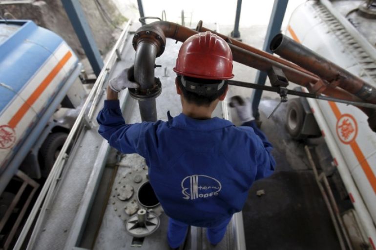 An employee fills the tank of a petrol delivery vehicle at a Sinopec refinery in Wuhan, Hubei province, in this April 25, 2012 file photo. China's emergence as a major oil product exporter is depressing oil refining margins across Asia as favourable domestic fuel policies encourage Chinese refiners to keep output high and flood regional markets with surplus supplies. REUTERS/Stringer/Files CHINA OUT. NO COMMERCIAL OR EDITORIAL SALES IN CHINA.