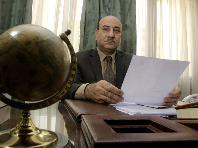 In this Tuesday, April 16, 2014 photo, Hesham Genena, the head of Egypt's oversight body, holds documents at his office in Cairo, Egypt. Genena has created uproar simply because he decided to actually do his job. The head of one of Egypt’s foremost government oversight agencies, he says he has uncovered billions of dollars-worth of corruption, including in the country’s most untouchable institutions, including the police, intelligence agencies, and the judiciary.(AP Photo/Amr Nabil)