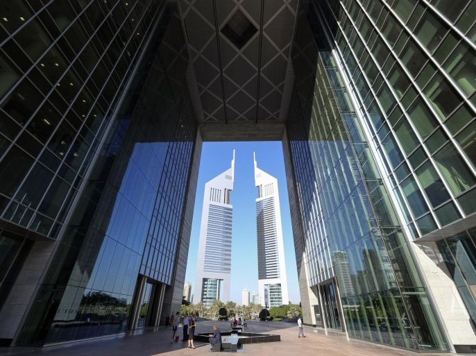 People are pictured at the Dubai International Financial Centre in this November 10, 2013 file photo. Islamic banking is based on core principles of the religion. So it is striking that some banks are removing the word "Islam" from their names - a sign of both the potential of Islamic finance to grow, and the obstacles to it becoming mainstream. REUTERS/Omr Mohamed/Files (UNITED ARAB EMIRATES - Tags: BUSINESS)