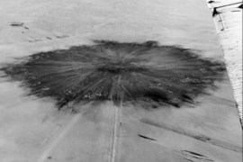 (FILES) This file picture taken 20 February 1960 shows an aerial view of the site of the first French nuclear bomb explosion in the Tanezrouft sahara desert, south-west of Reggane. The head of the Algerian victims of French nuclear tests organisation, Sahara Mohamed Abdelhak Bendjebbar, said 13 February 2007 that his organization will seek compensation through the United Nations' International Court of Justice. Bendjebbar, who did not say when the complaint would be filed, claimed the tests had injured some 30,000 Algerians. Algerian scientists contend that France carried out 17 nuclear tests in the Sahara desert between 1960 and the final withdrawal of French troops from the region in 1967.