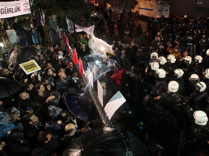 A handout picture released by the Zaman Daily News shows Turkish riot police raid Zaman newspaper building as they disperse supporters of Fethullah Gulen Movement protest outside of Zaman newspaper as Turkish Police try to get inside for taking over the control, in Istanbul, Turkey, 04 March 2016. The Turkish government will take control of Zaman, the largest opposition newspaper in the country, state-run Anadolu news agency reported on 04 March 2016 citing a court order. Under the order, a state appointed trusteeship will run the paper, which has editions in several languages, including Turkish and English. The staff of the Zaman newspapers in Turkey are preparing what they expect to be their final edition before government-appointed trustees take over the opposition media outlet. Zaman, which according to its own numbers averaged last year 850,000 print copies a day, is accused of being part of the network of Fethullah Gulen, an Islamic preacher based in the US. EPA/KURSAT BAYHAN / ZAMAN DAILY NEWS / HANDOUT