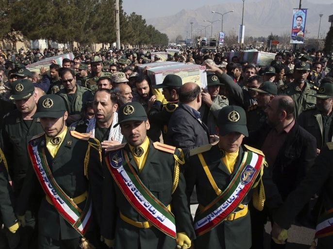 Civilians and armed forces members carry the flag draped coffins of Iranian Revolutionary Guard Gen. Mohsen Ghajarian and five soldiers who were killed in fighting in Syria, during their funeral ceremony outside the headquarters of the guard's ground forces, in Tehran, Iran, Saturday, Feb. 6, 2016. Iran has held a joint funeral for six soldiers who were killed while fighting alongside President Bashar Assad's forces in northern Syria while battling the Islamic State group and Syrian rebels. (AP Photo/Vahid Salemi)