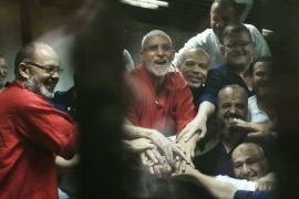 FILE -- In this June 16, 2015 file photo, Egyptian defendants including the spiritual leader of the Muslim Brotherhood, Mohammed Badie, center in orange, react to a court ruling in a makeshift courtroom at the Police Academy courthouse, in Cairo, Egypt. A spokesman says Jordan's branch of the Muslim Brotherhood has formally cut ties with the region-wide movement based in Egypt. The decision is the latest setback for the larger Brotherhood, once seen as the main political beneficiary of the Arab Spring uprisings, but hit hard in recent years by government crackdowns. (AP Photo/Hassan Ammar, File)