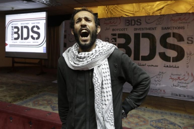 An Egyptian shouts anti-Israeli slogans in front of banners with the Boycott, Divestment and Sanctions (BDS) logo during the launch of the Egyptian campaign that urges boycott, divestment and sanctions against Israel and Israeli-made goods, at the Egyptian Journalists’ Syndicate in Cairo, Egypt, Monday, April 20, 2015. BDS is a global movement initiated by Palestinian civil society activists in 2005 that organizers say will continue until Israel complies with international law and respects Palestinian rights. (AP Photo/Amr Nabil)