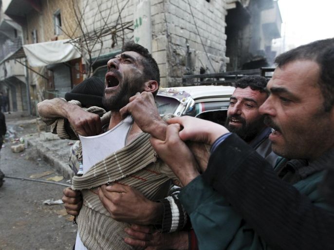 A father reacts after the death of two of his children, whom activists said were killed by shelling by forces loyal to Syria's President Bashar al-Assad, at al-Ansari area in Aleppo, Syria January 3, 2013. REUTERS/Muzaffar Salman SEARCH 'FIVE YEARS SYRIA' FOR ALL IMAGES
