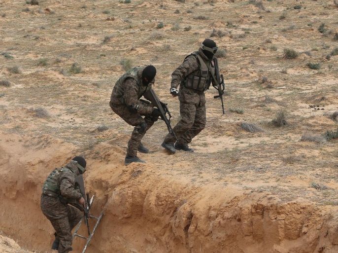 Tunisian army special forces take part in a military exercise on a trench dug along the Libyan border in near Ben Guerdane, eastern Tunisia, close to the border with Libya, 06 February 2016. Tunisian Defense Minister Farhat Horchani inspected the first completed part of the 196-kilometer ditch, which aims to render the entire border impassable by vehicles.